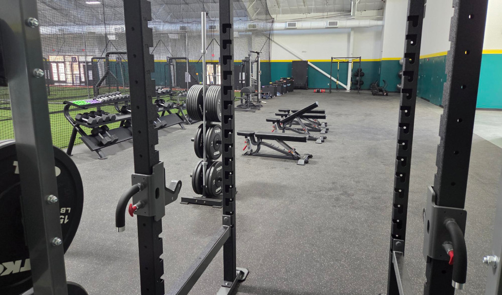 Weight room with racks benches barbells Weight room with racks benches barbells